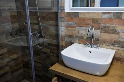 a bathroom with a sink and a shower at GUESTHOUSE Idila pod Nanosom in Senožeče