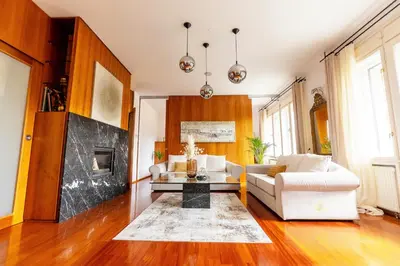 a living room with a couch and a fireplace at Luxury Apartment Villa Černigoj in Maribor