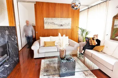 a living room with two white couches and a fireplace at Luxury Apartment Villa Černigoj in Maribor