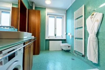 a bathroom with a sink and a toilet in it at Luxury Apartment Villa Černigoj in Maribor