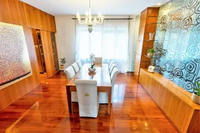 a dining room with a table and white chairs at Luxury Apartment Villa Černigoj in Maribor