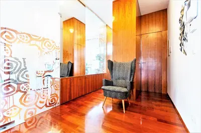 a room with a chair and a wall at Luxury Apartment Villa Černigoj in Maribor