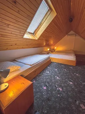 a room with two beds and a window at Eco tourist farm Mikl in Prevalje