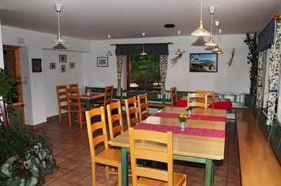 a dining room with a table and chairs at Eco tourist farm Mikl in Prevalje