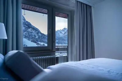 a bedroom with a window with a mountain view at Rož'ca apartments with mountain view in Mojstrana