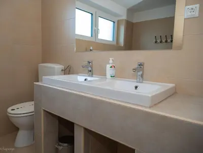 a bathroom with a sink and a toilet at Rož'ca apartments with mountain view in Mojstrana