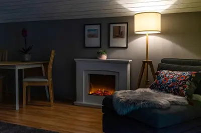 a living room with a couch and a fireplace at Rož'ca apartments with mountain view in Mojstrana