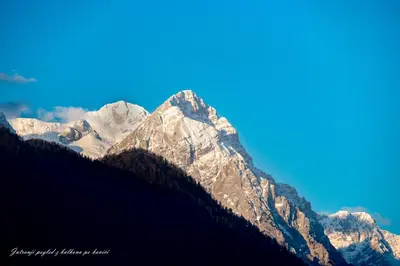 a view of a snow covered mountain range at Rož'ca apartments with mountain view in Mojstrana