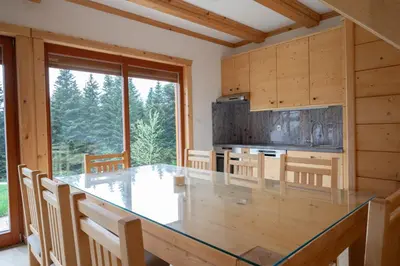 a dining room with a large glass table in a kitchen at Hiša Breza in Mozirje
