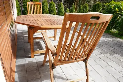 a wooden table and chair on a patio at Apartment Mari in Bohinj