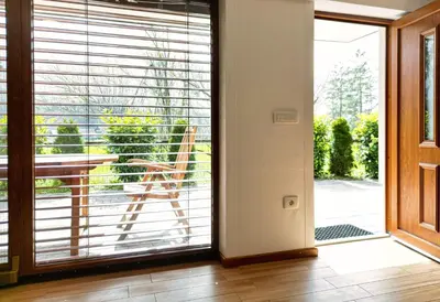 an open door to a balcony with blinds at Apartment Mari in Bohinj