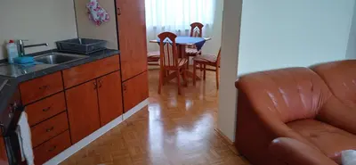 a kitchen with a couch and a sink and a table at Apartma Rogaska riviera in Rogaška Slatina