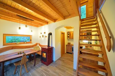 a home office with a wooden desk and a wooden staircase at Granaries Pear & Walnut in Tolmin