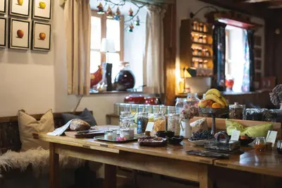 a table with food on it in a living room at Guesthouse Novak in Dvor