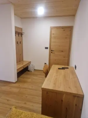 a room with a wooden table and a door at Turistična kmetija Ramšak in Zreče