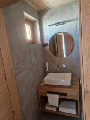 a bathroom with a sink and a mirror at Turistična kmetija Ramšak in Zreče