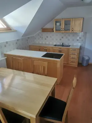 a kitchen with wooden cabinets and a wooden table at Turistična kmetija Ramšak in Zreče