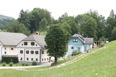 a group of houses on a grassy hill at Apartments Cvetje v Jeseni in Škofja Loka