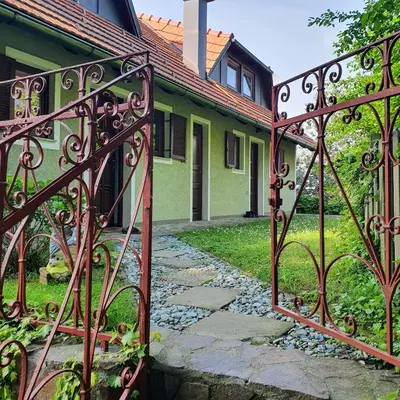 an iron gate in front of a house at Hiška pri Tisi in Ptujska Gora