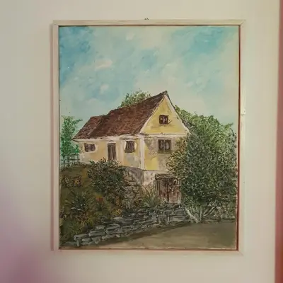 a painting of a house on a wall at Hiška pri Tisi in Ptujska Gora