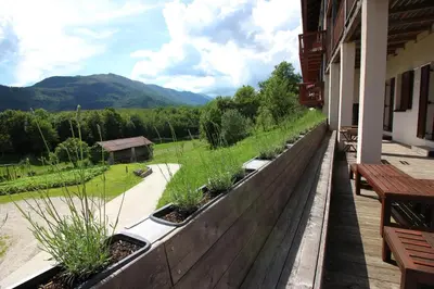 a balcony with benches and plants on a building at Apartments Pri Jakobu in Kobarid