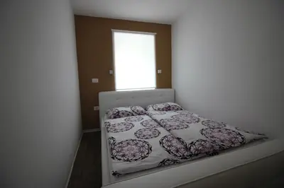 a bedroom with a bed in a room with a window at Apartments Pri Jakobu in Kobarid