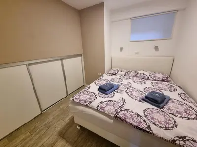 a bedroom with a bed with two blue towels on it at Apartments Pri Jakobu in Kobarid