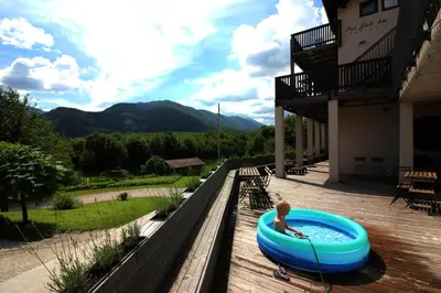 a young child in a pool on a deck at Apartments Pri Jakobu in Kobarid
