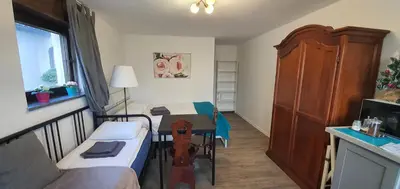 a small room with a bed and a table at DEKO-rooms in Ljubljana