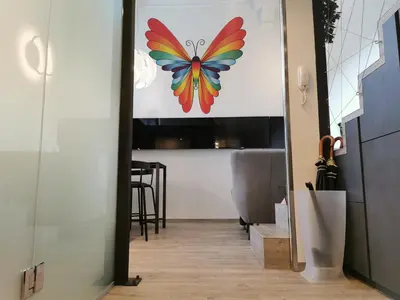 a butterfly painting on a wall in a hallway at DREAMY CENTER LOCATION in Ljubljana