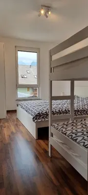 a bedroom with two bunk beds and a window at Apartma Valan in Bovec