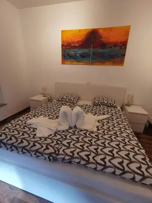 a bedroom with a bed with two towels on it at Apartma Valan in Bovec