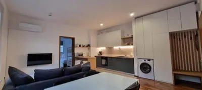 a living room with a couch and a kitchen at Apartma Valan in Bovec