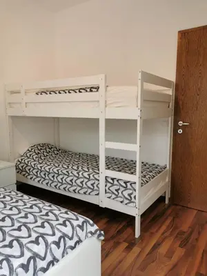 two bunk beds in a room with a wooden floor at Apartma Valan in Bovec
