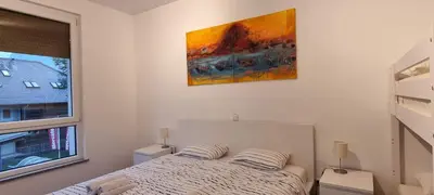 a bedroom with a bed and a painting on the wall at Apartma Valan in Bovec