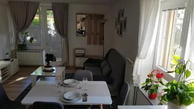 a living room with a table and a couch at Koradinovi - Pod vrtom in Vipava