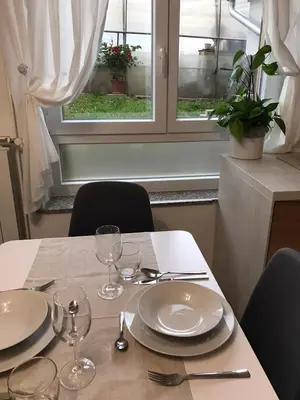 a table with plates and glasses on top of it at Koradinovi - Pod vrtom in Vipava
