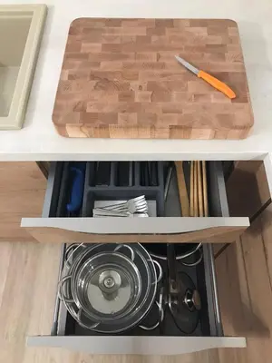 a drawer in a kitchen cabinet with a cutting board at Koradinovi - Pod vrtom in Vipava