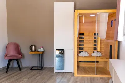 a room with a glass door and a chair at Boutique rooms by Petrič winery in Dobravlje