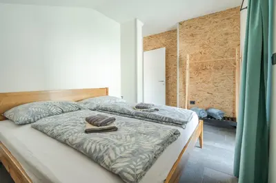 a bedroom with a bed with two towels on it at Holiday Home Lukc with free parking in Kobarid