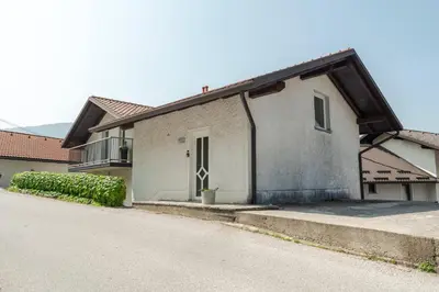 a white house with a door on a street at Holiday Home Lukc with free parking in Kobarid