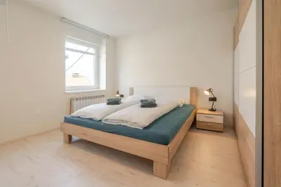 a bedroom with a bed in a room with a window at Holiday Home Lukc with free parking in Kobarid