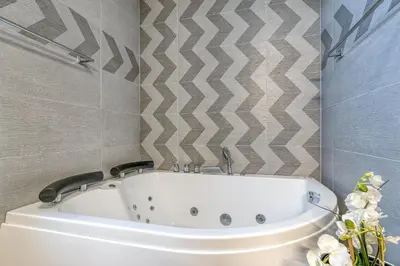 a bathroom with a white bath tub in a room at Pool & Whirlpool Art Villas in Trebnje