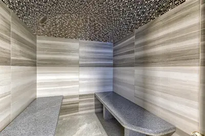 a bench in a room with a tile wall at Pool & Whirlpool Art Villas in Trebnje