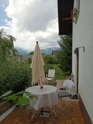 a white umbrella sitting on a table on a patio at Vrtnarjeva hiša, The Gardener's Cottage in Radovljica