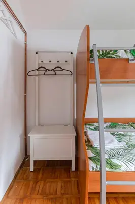 a bedroom with a bunk bed with a desk at Vrtnarjeva hiša, The Gardener's Cottage in Radovljica