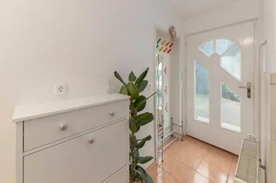 a room with a white dresser and a window at Vrtnarjeva hiša, The Gardener's Cottage in Radovljica