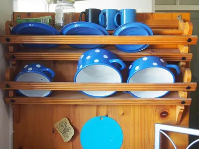 a bunch of plates and cups on a shelf at Tony's Old Farm in Begunje na Gorenjskem