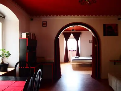 an archway in a living room with a bed in the background at Tony's Old Farm in Begunje na Gorenjskem