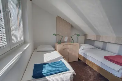 a bedroom with two beds and a window at Apartments Jojo in Bovec